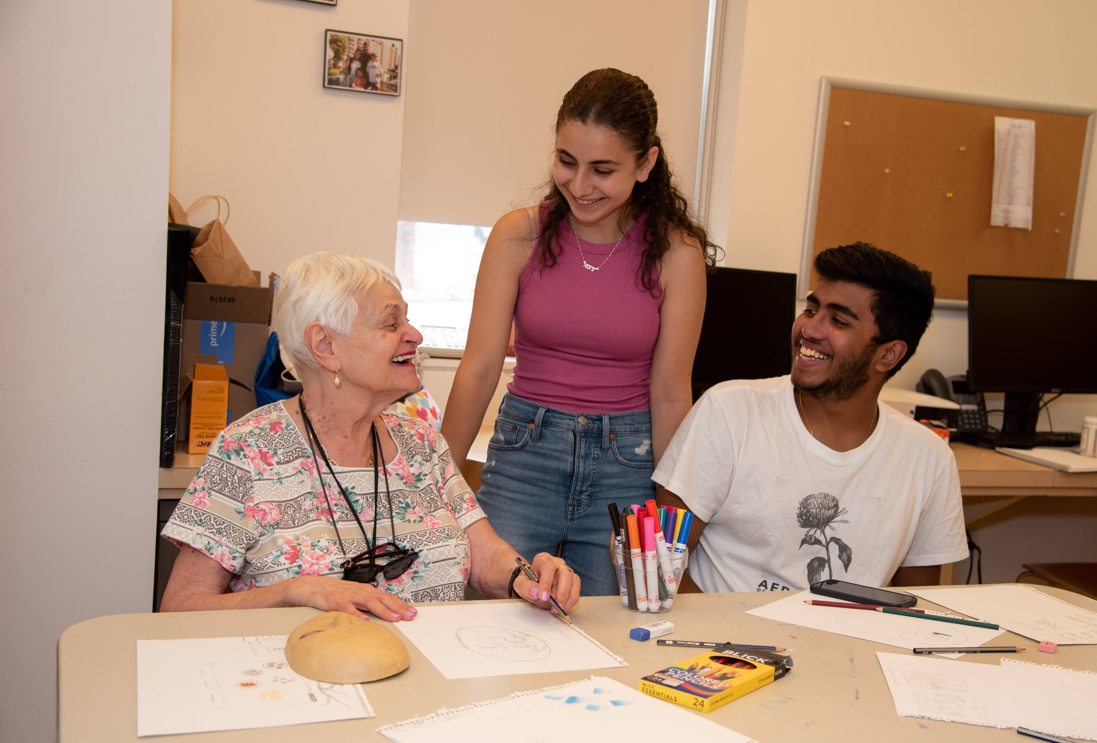 an older adults laughing with two teens